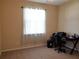 Bedroom with neutral paint, tile floor, and window letting in natural light at 1057 Staley St, Port Charlotte, FL 33952