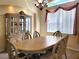 Elegant dining room features ornate furniture, chandelier lighting, and window with valance at 1057 Staley St, Port Charlotte, FL 33952