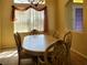 Cozy dining area with natural light, wood table, and decorative window treatment at 1057 Staley St, Port Charlotte, FL 33952