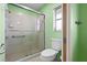 Updated bathroom with glass enclosed shower, tile, and modern fixtures at 1845 Edison Dr, Englewood, FL 34224