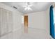 A clean and spacious bedroom with tile flooring and a ceiling fan at 1845 Edison Dr, Englewood, FL 34224