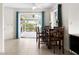 The dining area has tile flooring, a table with four chairs and windows at 1845 Edison Dr, Englewood, FL 34224