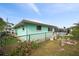 Property exterior featuring a fenced backyard, fire pit, and manicured landscaping at 1845 Edison Dr, Englewood, FL 34224