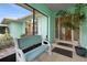 Charming front porch featuring a comfortable bench and decorative plants, leading to a glass-paneled entrance at 1845 Edison Dr, Englewood, FL 34224