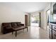 Bright living room with tile floors, a sliding glass door to the pool area, and contemporary decor at 1845 Edison Dr, Englewood, FL 34224