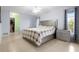 A cozy main bedroom with a neutral palette, tile floors, and a walk-in closet at 1845 Edison Dr, Englewood, FL 34224