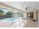 The patio is fully screened, and allows access to the pool and surrounding garden at 1845 Edison Dr, Englewood, FL 34224