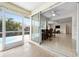 View from patio shows dining area, living room, and access to outdoor swimming pool at 1845 Edison Dr, Englewood, FL 34224