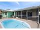 Backyard features a private swimming pool and screened-in patio, perfect for entertaining at 1845 Edison Dr, Englewood, FL 34224