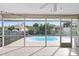 Screened-in lanai showcases a sparkling pool, providing a serene outdoor living space with backyard views at 1845 Edison Dr, Englewood, FL 34224