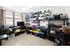 Bright, multi-purpose room with tile flooring, storage shelves, and ceiling fan at 1845 Edison Dr, Englewood, FL 34224