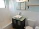 Bright bathroom with white tiled walls, vanity sink, and updated fixtures at 2488 Warne St, Port Charlotte, FL 33952