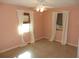 Bedroom featuring neutral walls and two windows, with a ceiling fan for added comfort at 2488 Warne St, Port Charlotte, FL 33952