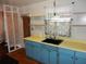 Kitchen with blue cabinets, open shelves, and a view to another room at 2488 Warne St, Port Charlotte, FL 33952