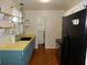 Bright kitchen with blue cabinets, open shelving, and a black refrigerator at 2488 Warne St, Port Charlotte, FL 33952