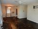 Spacious living room with a ceiling fan, large window, and an opening to another room at 2488 Warne St, Port Charlotte, FL 33952