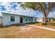 Charming single-story home featuring a well-maintained lawn, inviting entryway, and a large shade tree in the front yard at 3461 Normandy Dr, Port Charlotte, FL 33952
