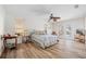 Bright primary bedroom with wood floors, a ceiling fan, and doors to the backyard at 472 Eppinger Dr, Port Charlotte, FL 33953
