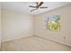 A simple bedroom with carpet and window, well-lit by natural light at 472 Eppinger Dr, Port Charlotte, FL 33953