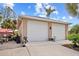 Detached two car garage and driveway with a boat and boat trailer on the side at 472 Eppinger Dr, Port Charlotte, FL 33953