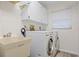 Functional laundry room with washer, dryer, sink and storage at 472 Eppinger Dr, Port Charlotte, FL 33953