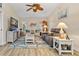 A spacious living room with a ceiling fan, a TV, and a comfortable couch at 472 Eppinger Dr, Port Charlotte, FL 33953