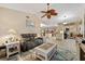 An open-concept living room with a ceiling fan, a couch, and a view into the kitchen at 472 Eppinger Dr, Port Charlotte, FL 33953