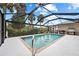 Inviting screened-in pool area with a grill, perfect for outdoor entertaining at 472 Eppinger Dr, Port Charlotte, FL 33953