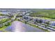 Overhead shot of the condominium community near a lake and wetland area with vehicle parking at 14091 Heritage Landing Blvd # 121, Punta Gorda, FL 33955