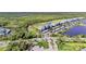 Community aerial view showcasing lush landscaping, water views, and modern condominium buildings at 14091 Heritage Landing Blvd # 121, Punta Gorda, FL 33955