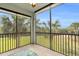 This screened balcony with views of mature landscaping and neighborhood streets is a peaceful outdoor space at 14091 Heritage Landing Blvd # 121, Punta Gorda, FL 33955