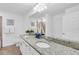 The bathroom features a double-sink vanity with granite countertops and a decorative sailboat at 14091 Heritage Landing Blvd # 121, Punta Gorda, FL 33955