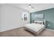 Cozy bedroom with a queen-sized bed, soft carpet, and a pop of color from the accent wall at 14091 Heritage Landing Blvd # 121, Punta Gorda, FL 33955