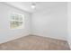 Bright, empty bedroom with natural light from the window and neutral carpet, ready for customization at 14091 Heritage Landing Blvd # 121, Punta Gorda, FL 33955