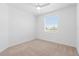 Minimalist bedroom featuring a window, neutral carpet and white walls creating a calm and bright space at 14091 Heritage Landing Blvd # 121, Punta Gorda, FL 33955