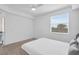 Bright bedroom featuring a ceiling fan, plush carpet, and a large window with natural light at 14091 Heritage Landing Blvd # 121, Punta Gorda, FL 33955