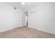 A large bedroom with neutral carpet featuring two doors and a closet at 14091 Heritage Landing Blvd # 121, Punta Gorda, FL 33955