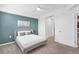 Well-lit bedroom with ceiling fan and a queen bed, complemented by teal wall and hallway access at 14091 Heritage Landing Blvd # 121, Punta Gorda, FL 33955