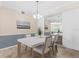 Bright dining room features contemporary furniture, stylish lighting, and neutral paint colors at 14091 Heritage Landing Blvd # 121, Punta Gorda, FL 33955