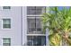 Exterior shot of the condo featuring a screened patio and a palm tree at 14091 Heritage Landing Blvd # 121, Punta Gorda, FL 33955