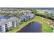 Three-story condominiums overlooking the lake, a golf course, and lush landscaping at 14091 Heritage Landing Blvd # 121, Punta Gorda, FL 33955