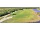 Scenic golf course view with lush green fairways and a tranquil lake backdrop at 14091 Heritage Landing Blvd # 121, Punta Gorda, FL 33955