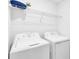 The laundry room is equipped with a full-sized washer, a dryer and shelving at 14091 Heritage Landing Blvd # 121, Punta Gorda, FL 33955