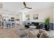 Spacious living room and kitchen area feature tiled floors, ceiling fan, breakfast bar, and stainless appliances at 14091 Heritage Landing Blvd # 121, Punta Gorda, FL 33955