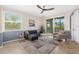 Comfortable living room boasts tiled floors, contemporary furniture, large windows, and access to outdoor balcony at 14091 Heritage Landing Blvd # 121, Punta Gorda, FL 33955