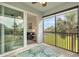 Relax on the screened patio with a ceiling fan, overlooking a lush, green lawn at 14091 Heritage Landing Blvd # 121, Punta Gorda, FL 33955