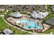 Aerial view of the community pool, lounge chairs, and beautiful landscaping to enjoy the Florida sunshine at 14091 Heritage Landing Blvd # 121, Punta Gorda, FL 33955