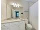 Well-lit bathroom featuring granite countertops, white cabinetry, and decorative accents at 15169 Spanish Point Dr, Port Charlotte, FL 33981