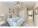 Cozy bedroom featuring a queen bed, ceiling fan, and decorative wall art at 15169 Spanish Point Dr, Port Charlotte, FL 33981