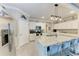 Well-equipped kitchen features a large island with seating, stainless steel appliances, and ample cabinet space at 15169 Spanish Point Dr, Port Charlotte, FL 33981